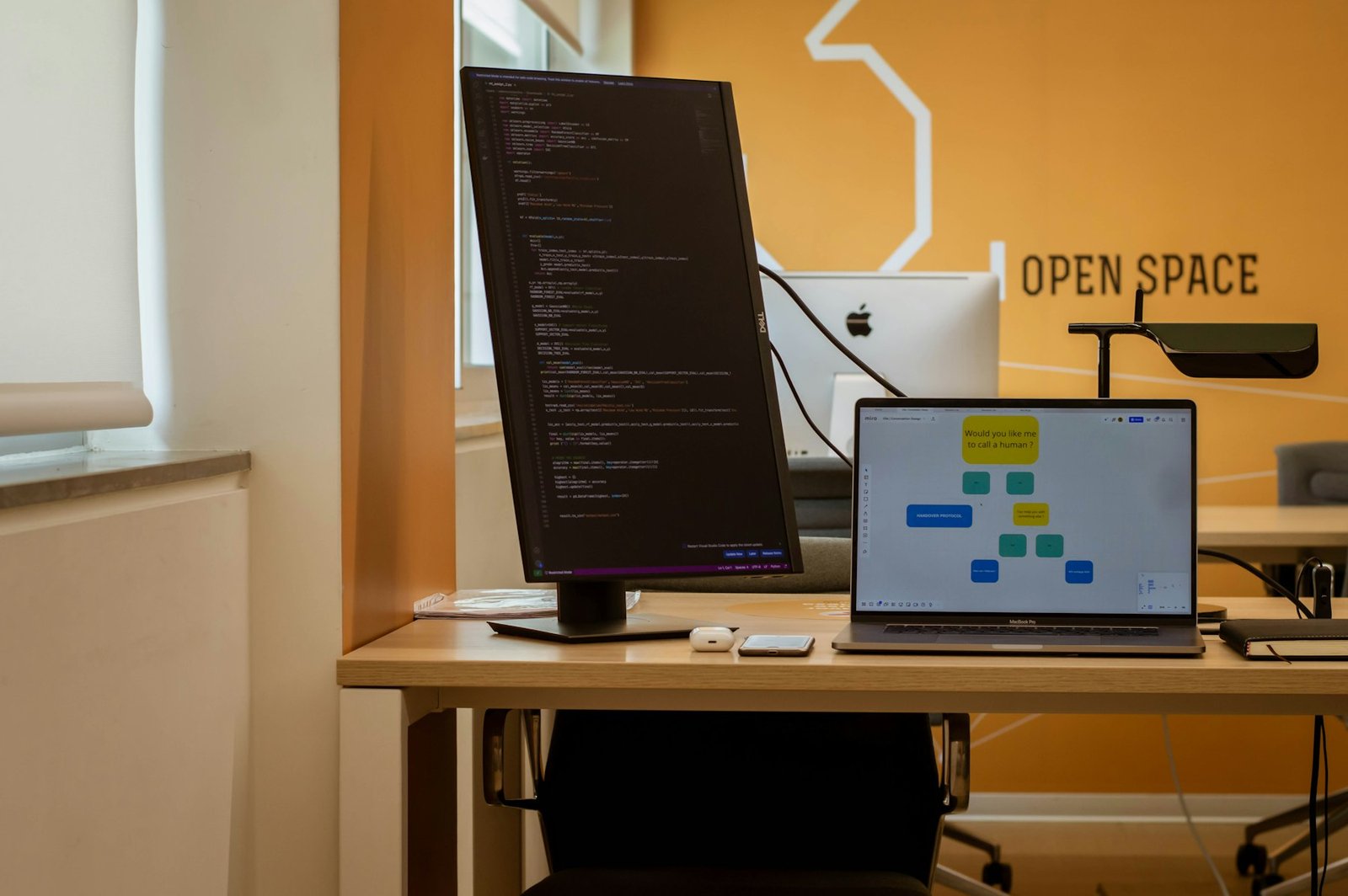Laptop open on a clean wooden desk workspace