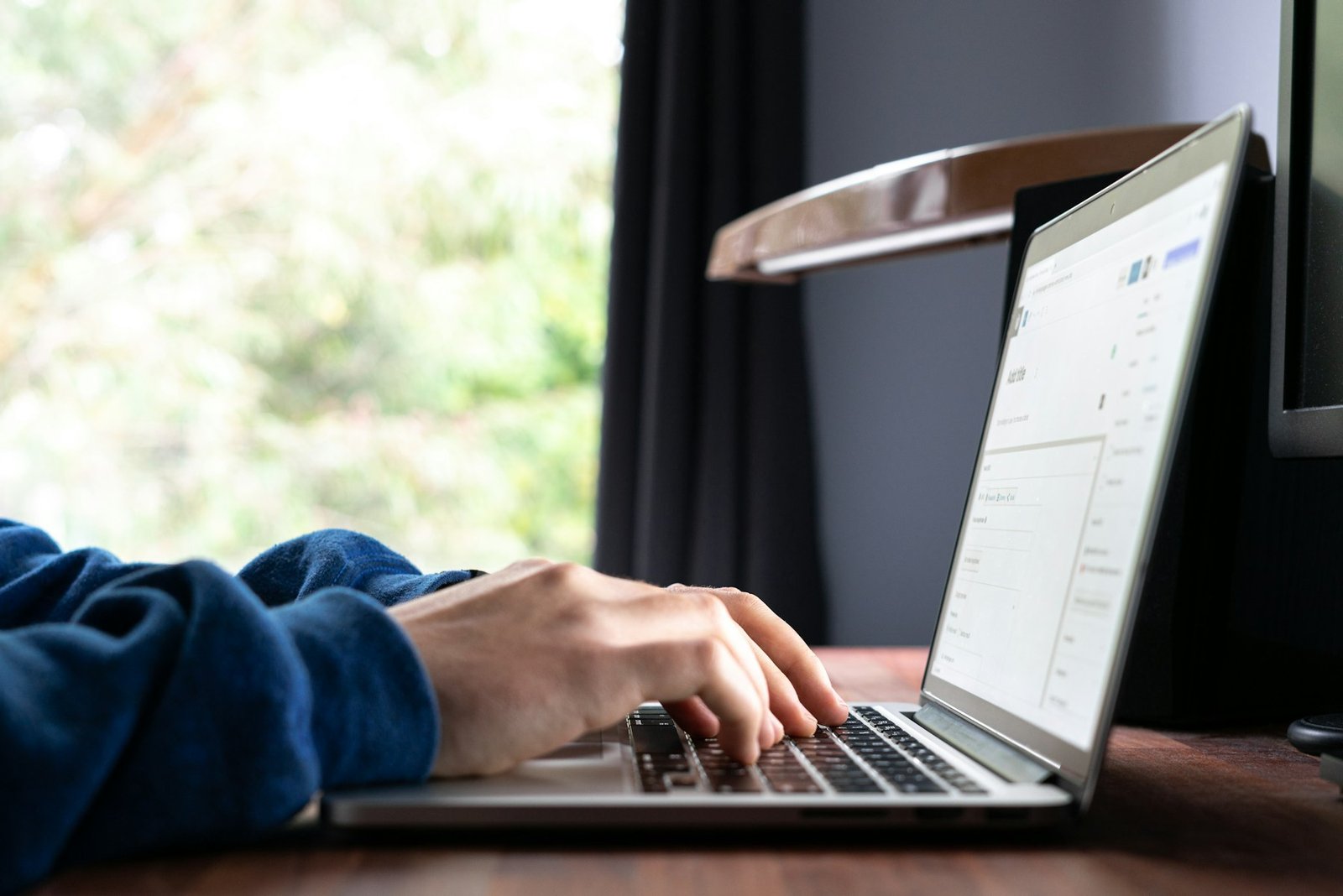 Person typing a message on a laptop